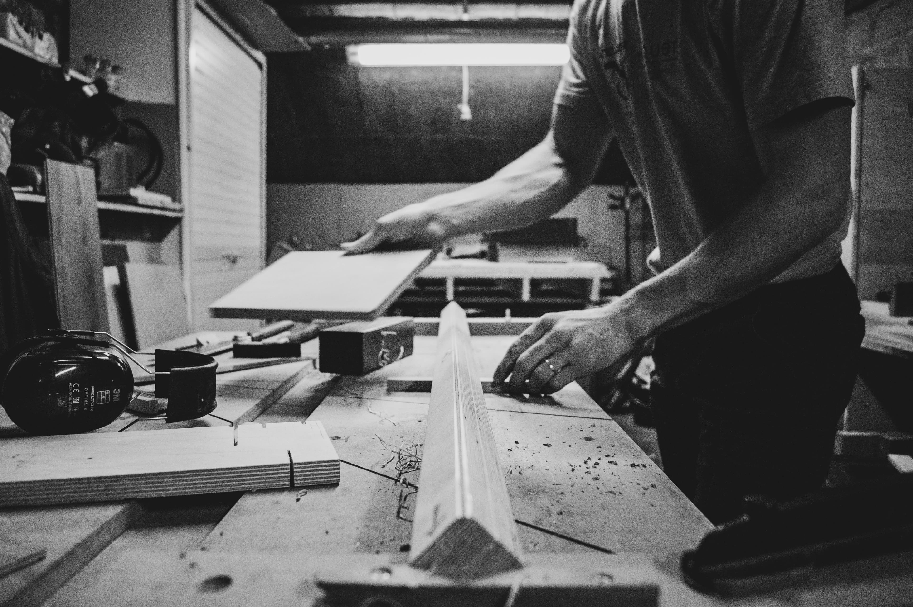 Joiner working with timber at a workshop bench