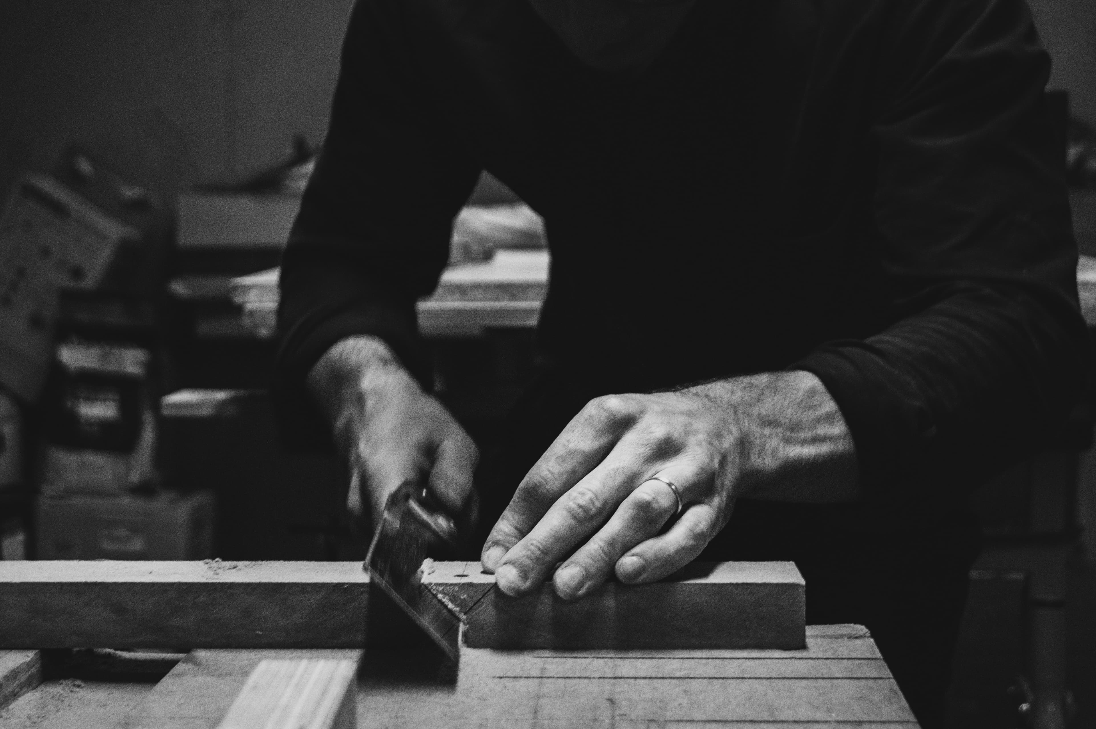 Close-up of a joiner working by hand on a timber component